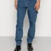 Karl Kani RETRO WORKWEAR - Jeans Tapered Fit - Dark Indigo, Herren 1 Karl Kani RETRO WORKWEAR - Jeans Tapered Fit - Dark Indigo, Herren -Outlet KARL KANI Store 20a42ab2304348a584a2a89b87078b26