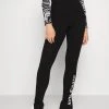 Karl Kani RETRO SLIT - Leggings - Hosen - Black, Damen 1 Karl Kani RETRO SLIT - Leggings - Hosen - Black, Damen -Outlet KARL KANI Store b482b8612ed044c18ab48071bdb0a8a4